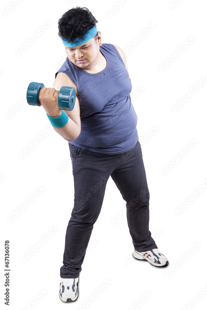 Overweight man excercising with dumbbell Overweight man excercising with dumbbell