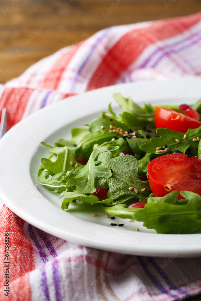 Green salad made with  arugula, tomatoes and sesame