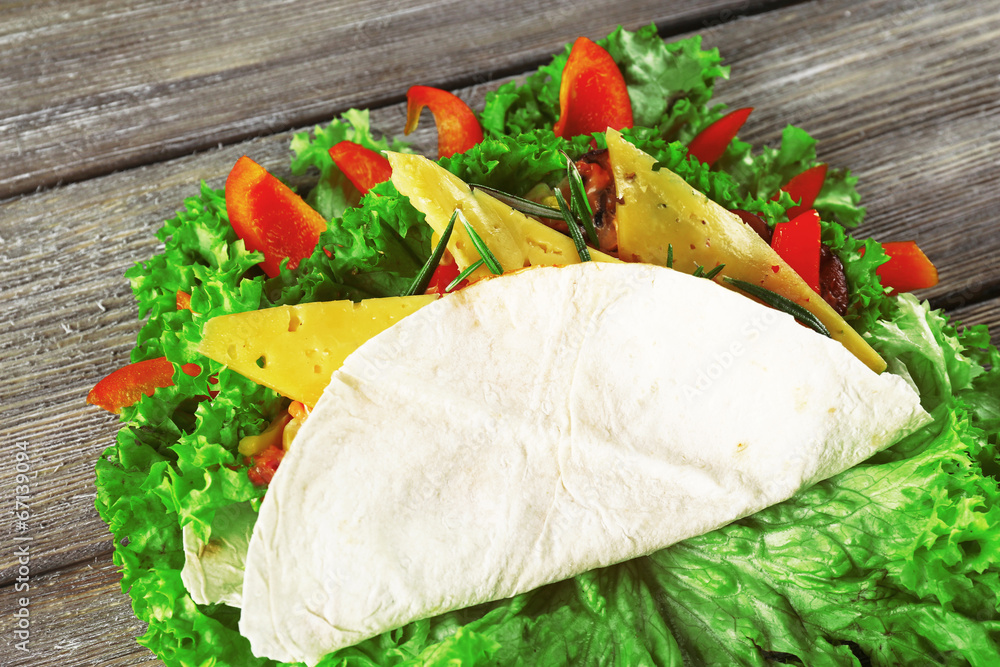 Veggie wrap filled with cheese and fresh vegetables Veggie wrap filled with cheese and fresh vegetables