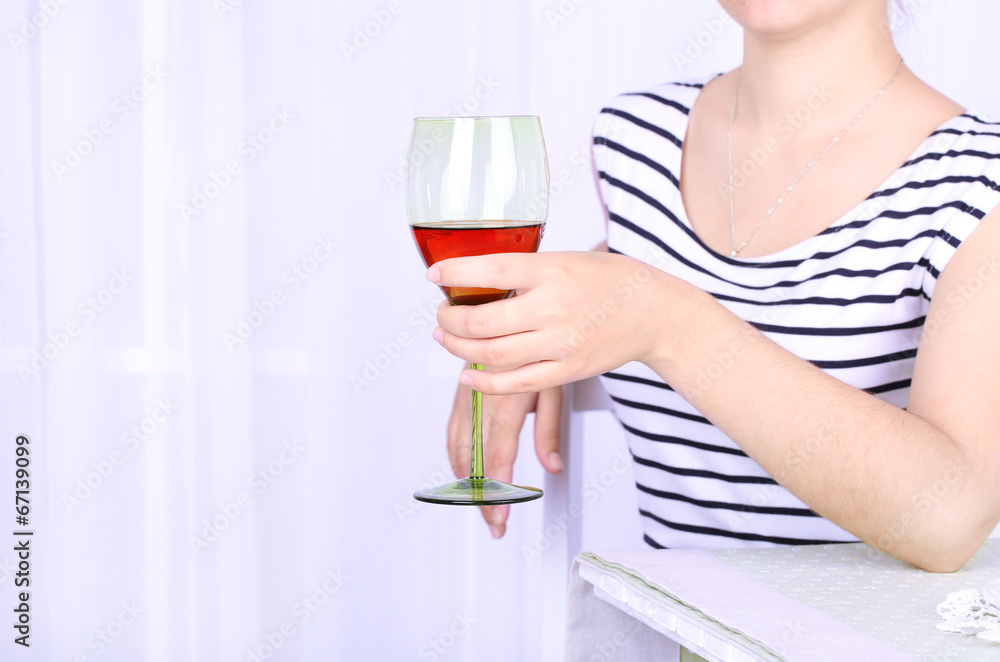 Young woman with glass of red wine