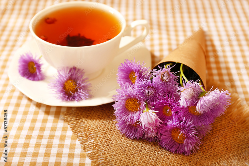 Cup of fresh herbal tea on table