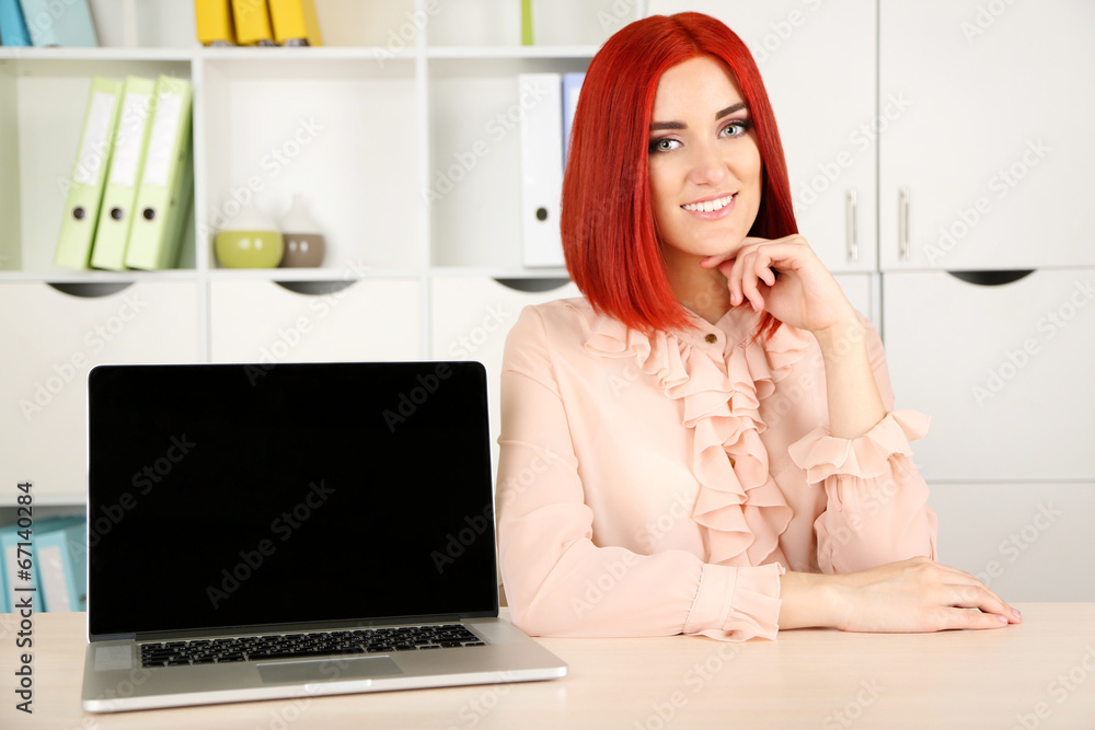 Young beautiful business woman with laptop in cabinet Young beautiful business woman with laptop in cabinet