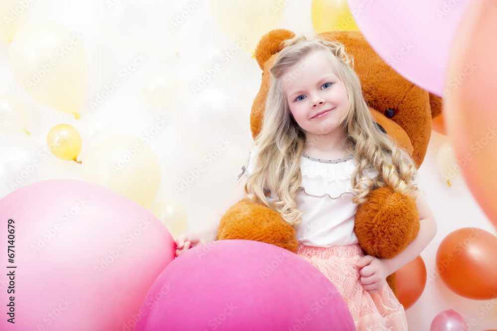 Smiling blonde girl playing with teddy bear Smiling blonde girl playing with teddy bear
