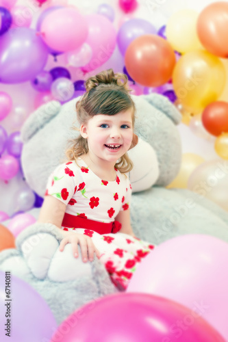 Image of merry little girl posing in playroom