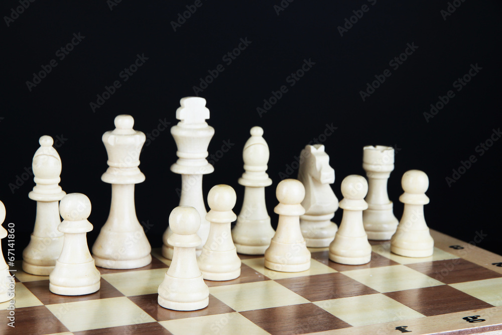 Chess board with chess pieces isolated on black Chess board with chess pieces isolated on black
