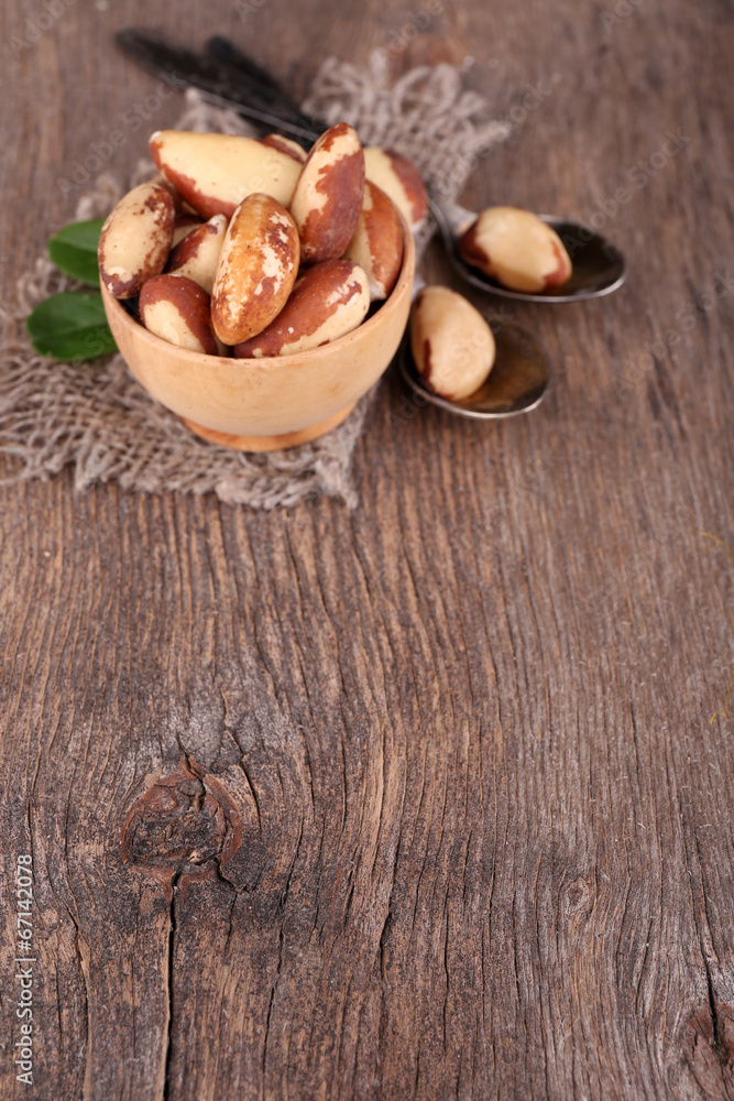Fototapeta premium Tasty brasil nuts on wooden background