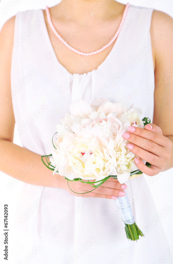 Bride holding wedding bouquet of white peonies, close-up Bride holding wedding bouquet of white peonies, close-up