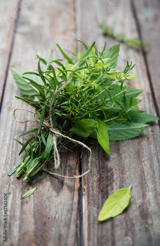 bunch of fresh herbs on wooden rustic planks