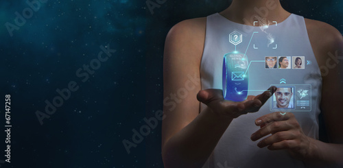 Unrecognizable woman holding wearable gadget