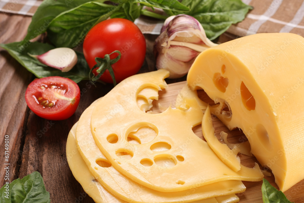 Cheese on a cutting board, basil, tomato Cheese on a cutting board, basil, tomato