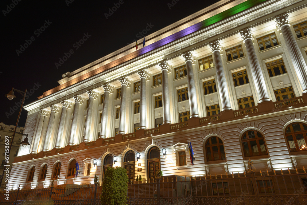 Illuminated building of Romanian National Bank (BNR) in the old city of Bucharest at night