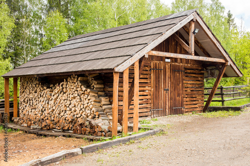 Wooden shed and logs