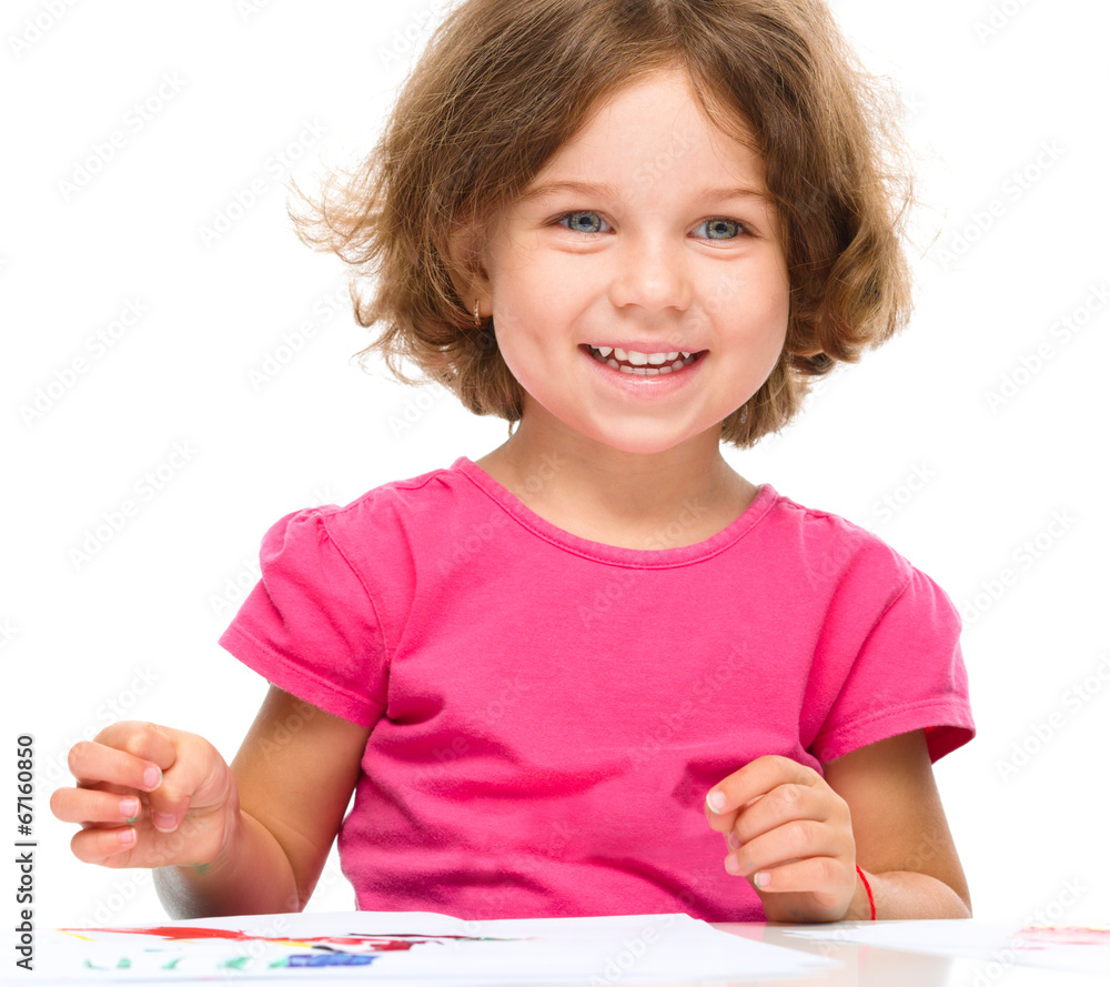Little girl is painting with gouache Little girl is painting with gouache