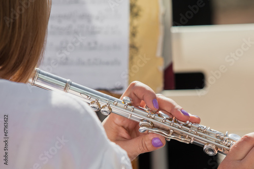 Hands girl playing a flute closeup