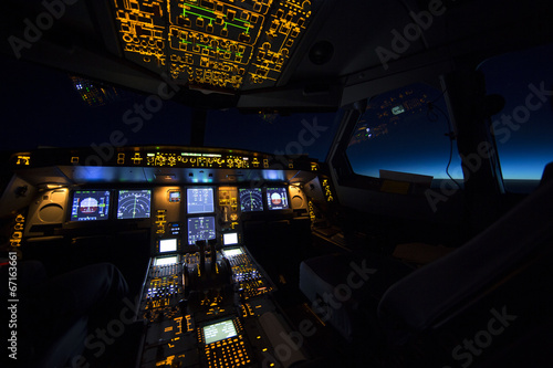 Cockpit of aircraft at sunrise or sunset