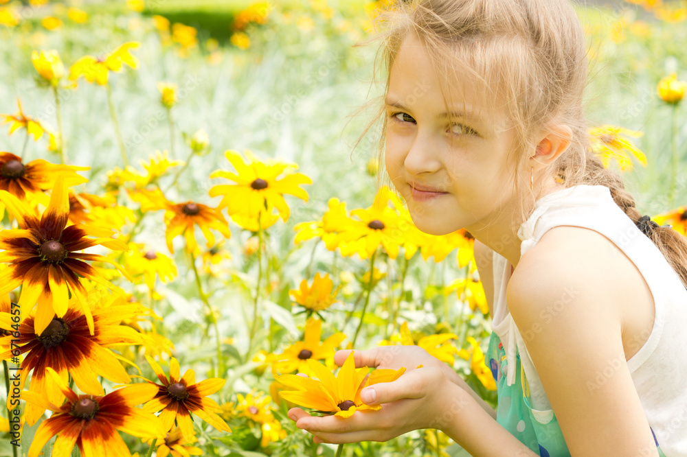 Smiling pretty little girl amongst summer flowers Smiling pretty little girl amongst summer flowers