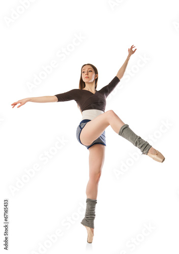 Beautiful ballet dancer posing in studio