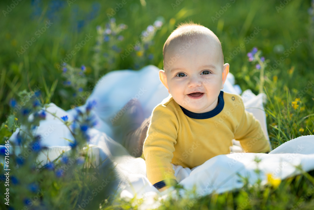 little child lying on a diaper the grass