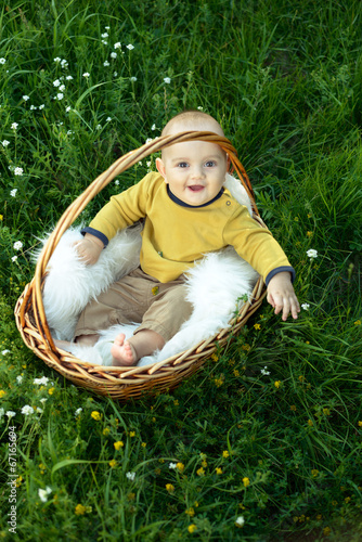 small smiling childin sitting in a basket photo