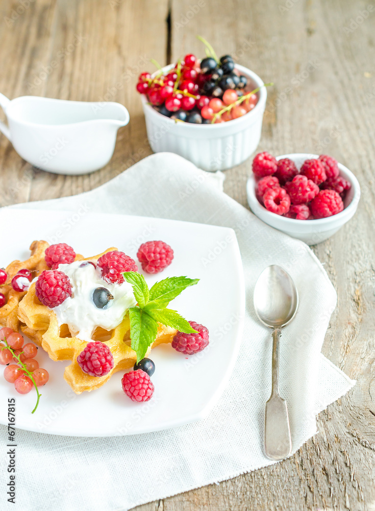 Belgian waffles with whipped cream and fresh berries Belgian waffles with whipped cream and fresh berries