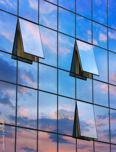 reflection in open windows  of  skyscraper at sunset
