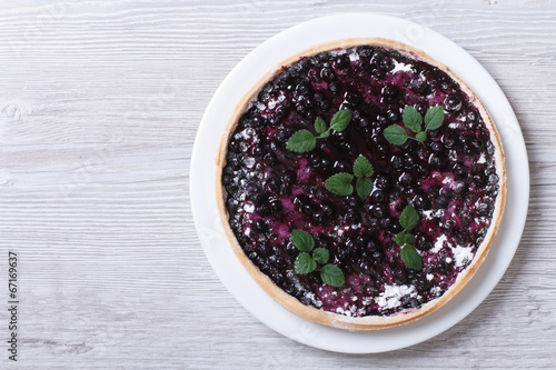blueberry pie with mint on wooden top view