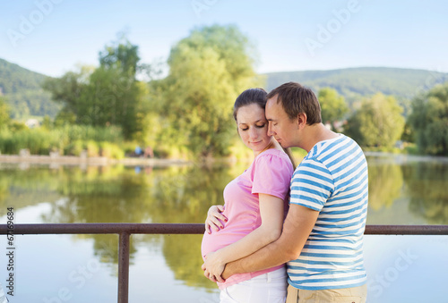Pregnant couple by the lake