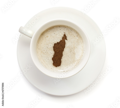 Cup of coffee with foam and powder in the shape of Madagascar.(s