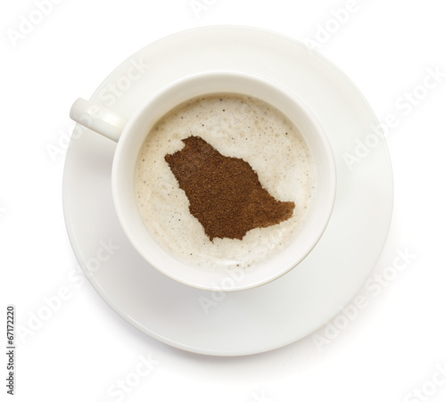 Cup of coffee with foam and powder in the shape of Saudi Arabia.