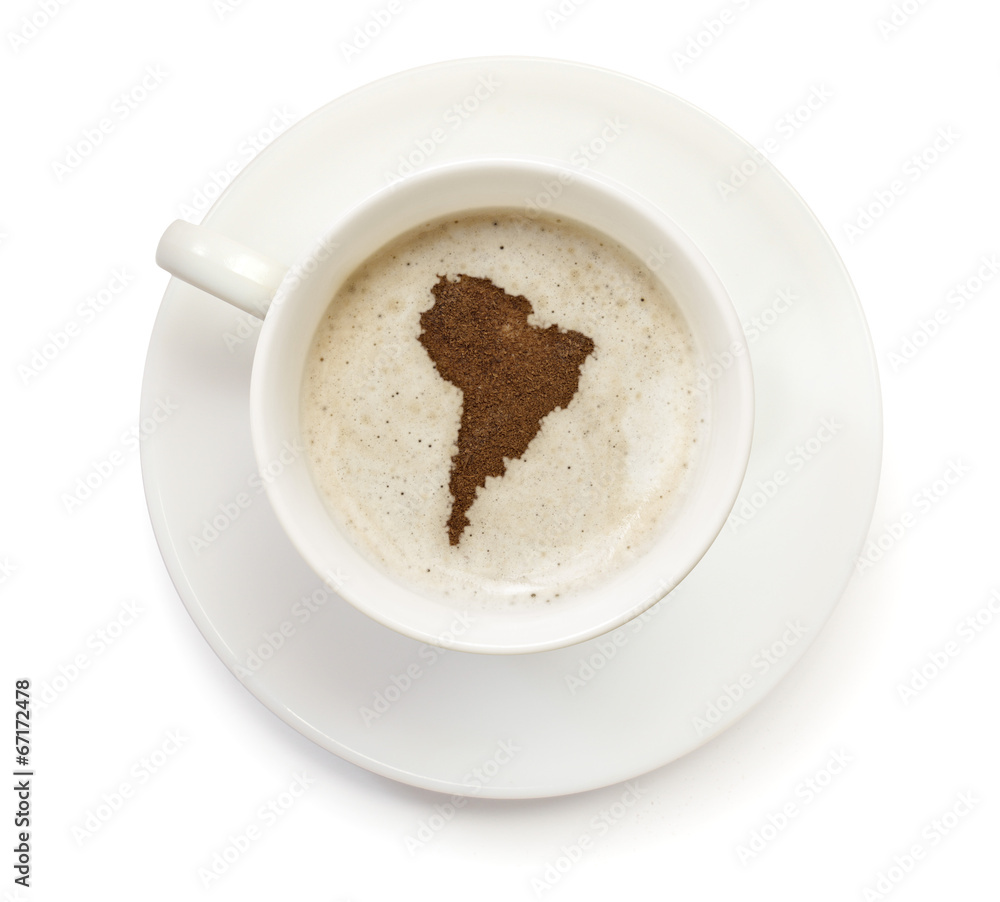 Cup of coffee with foam and powder in the shape of South America Cup of coffee with foam and powder in the shape of South America
