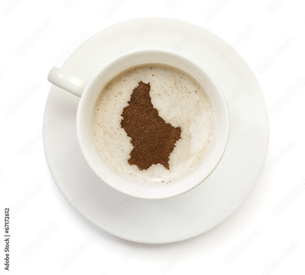 Cup of coffee with foam and powder in the shape of Luxembourg.(s Cup of coffee with foam and powder in the shape of Luxembourg.(s