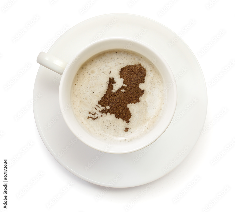 Cup of coffee with foam and powder in the shape of Netherlands.( Cup of coffee with foam and powder in the shape of Netherlands.(