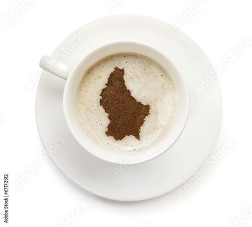 Cup of coffee with foam and powder in the shape of Luxembourg. s