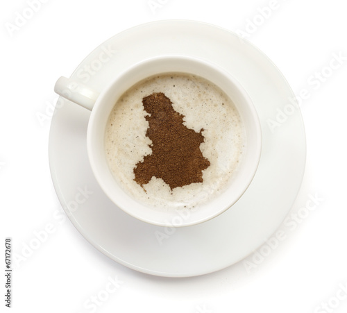 Cup of coffee with foam and powder in the shape of Serbia Monten
