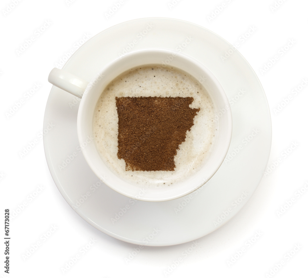 Cup of coffee with foam and powder in the shape of Arkansas.(ser Cup of coffee with foam and powder in the shape of Arkansas.(ser