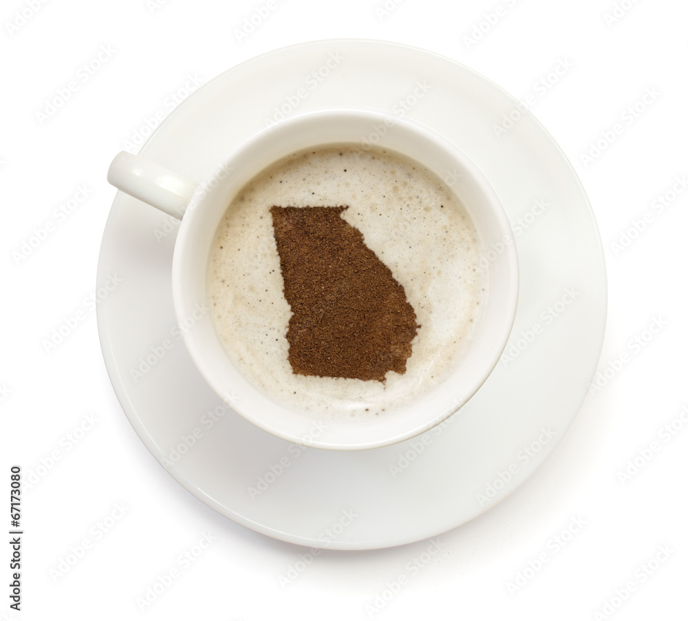 Cup of coffee with foam and powder in the shape of Georgia.(seri Cup of coffee with foam and powder in the shape of Georgia.(seri