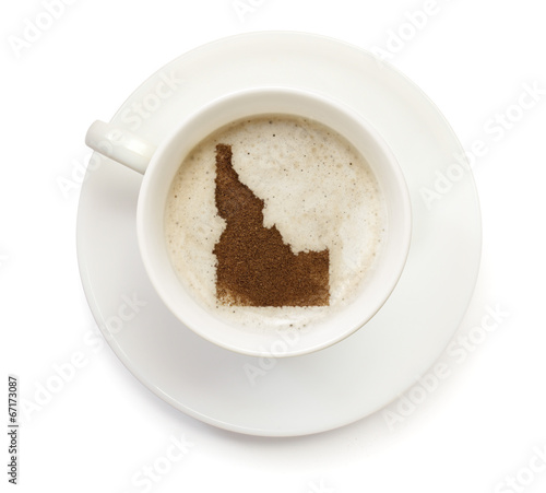 Cup of coffee with foam and powder in the shape of Idaho.(series