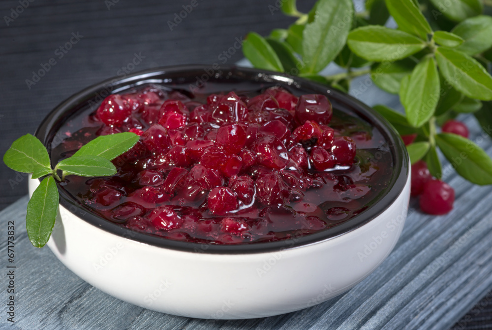 lingonberry jam (cowberries) and branches with leaves lingonberry jam (cowberries) and branches with leaves