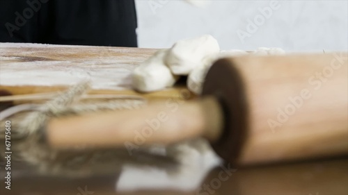 female cutting dough into pieces,dolly shot photo