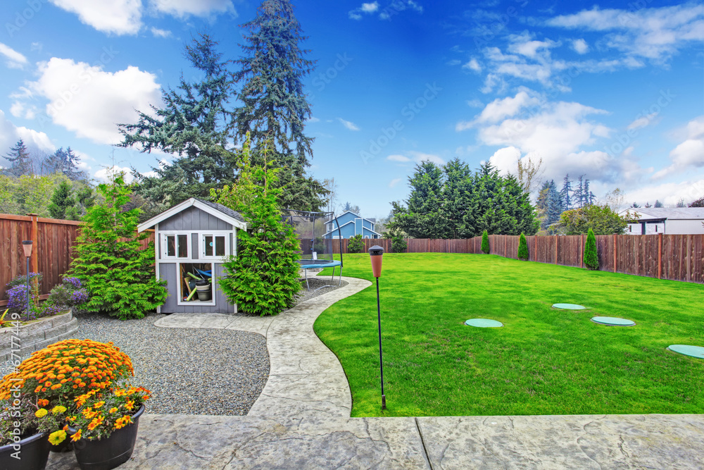 Fenced backyard with lawn and shed