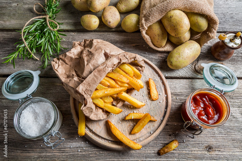 Closeup of homemade fries with ketchup and salt