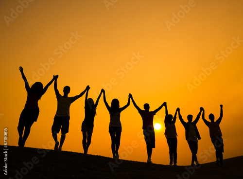 Group of People Holding Hands in Back Lit