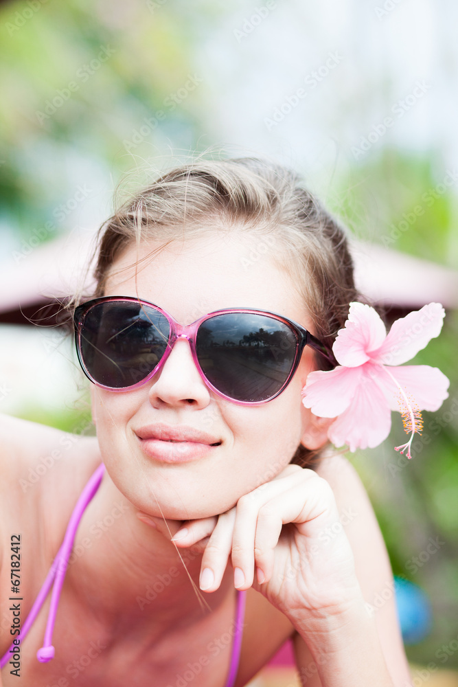 beautiful young woman in bikini with flower in hair beautiful young woman in bikini with flower in hair