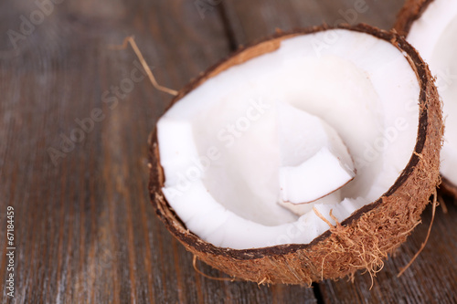 Broken coconut on wooden background