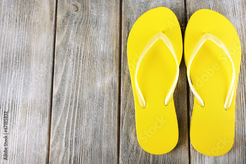 Colorful flip-flops on wooden background