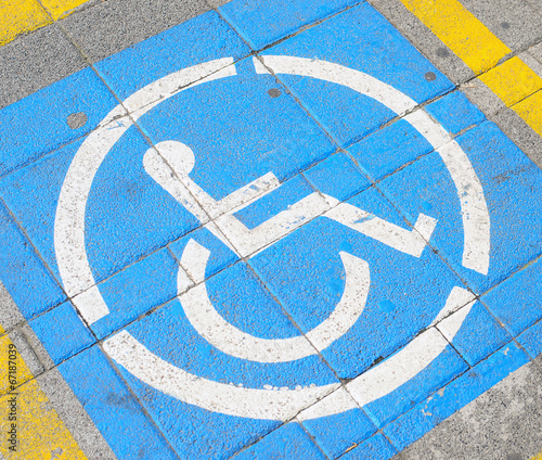 Parkingspace for disabled with wheelchair symbol on street floor photo