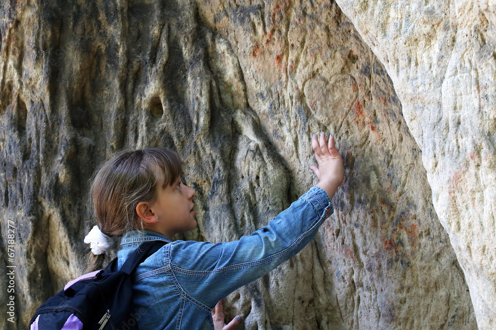 girl touch a granite rock outdoors girl touch a granite rock outdoors