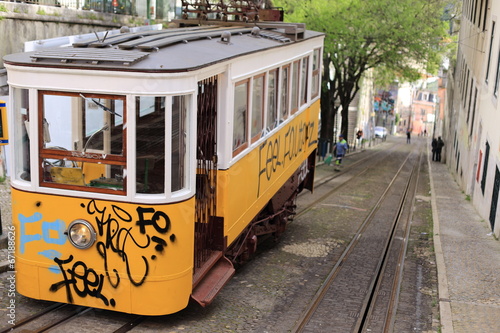 Yellow tram with graffity in lisbon