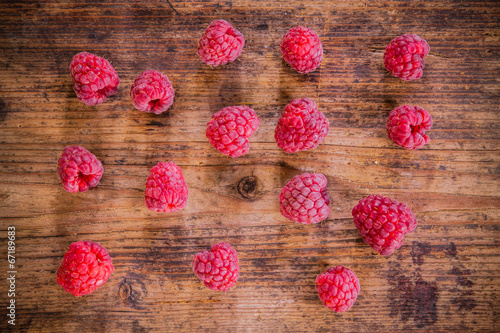raspberries on the old wooden background