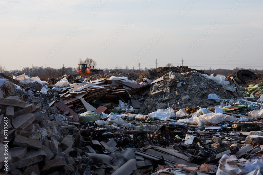Garbage on the landfill and working bulldozer Garbage on the landfill and working bulldozer